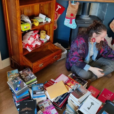 Anna sorting items from shelves