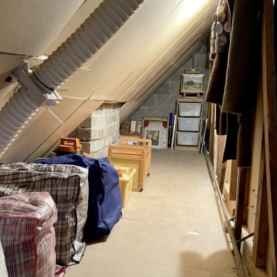 Decluttered attic space after organising with covered insulation